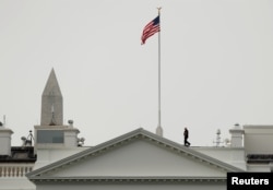 The U.S. flag flies at full staff less than 48 hours after John McCain's death over the White House in Washington, Aug. 27, 2018.