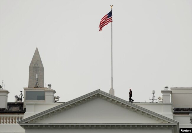 The U.S. flag flies at full staff less than 48 hours after John McCain's death over the White House in Washington, Aug. 27, 2018.