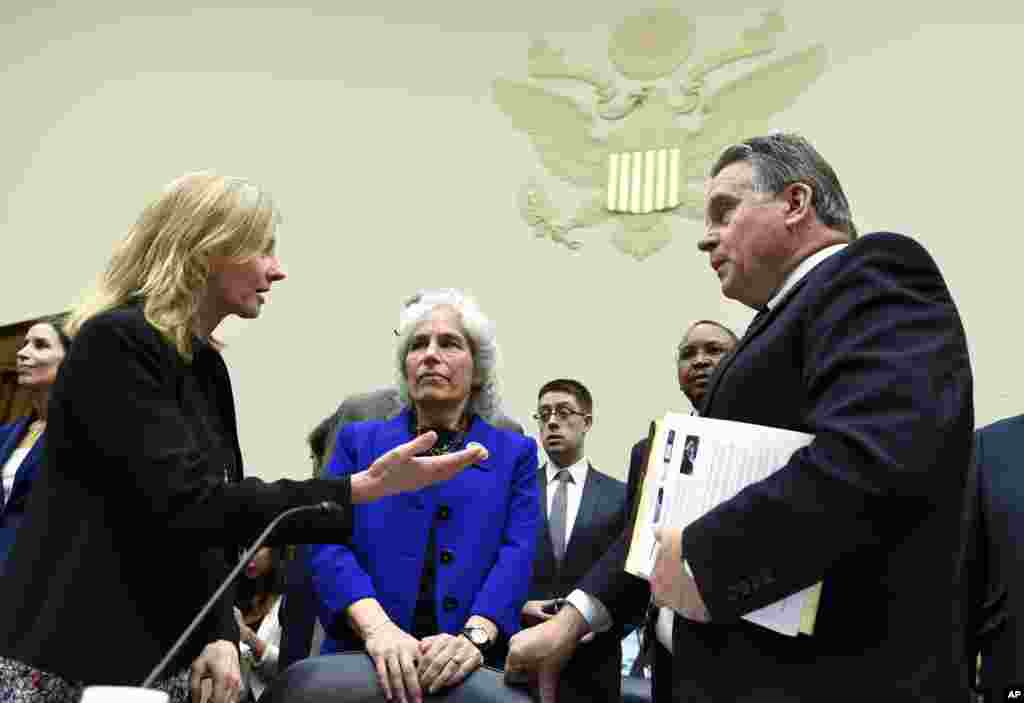 Subcommittee Chairman Rep. Christopher Smith, R-N.J., right, talks with Nancy Lindborg before her testimony on Capitol Hill, Sept. 17, 2014.