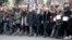 Charlie Hebdo magazine staff, with cartoonist Renald Luzier, known as Luz, front third left with mustache, march with relatives, right, of Jewish victim of the koscher supermarket, Michel Saada, in Paris, Jan. 11, 2015.