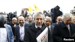 Cumhuriyet editor-in-chief Can Dundar, center, arrives at the Justice Palace in Istanbul, Turkey, March 25, 2016.