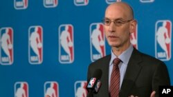 FILE - NBA Commissioner Adam Silver speaks to reporters, Oct. 21, 2016, in New York. Silver and NBA Players Association executive director Michele Roberts helped broker a tentative seven-year, collective bargaining agreement, Wednesday, Dec. 14, 2016. 