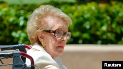 FILE - Former first lady of the United States Nancy Reagan visits the grave site of her husband, former United States President Ronald Reagan, on the 10th anniversary of his passing, in Simi Valley, California June 5, 2014. 