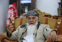 FILE - Former Afghan Cabinet minister and regional governor Ismail Khan speaks during an interview with the Associated Press in Herat province, western Afghanistan, Feb. 20, 2019.