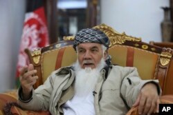 FILE - Former Afghan Cabinet minister and regional governor Ismail Khan speaks during an interview with the Associated Press in Herat province, western Afghanistan, Feb. 20, 2019.