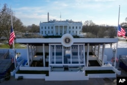 Workers continue with the finishing touches on the presidential reviewing stand on Pennsylvania outside the White House, Jan. 16, 2025, in Washington, ahead of President-elect Donald Trump's inauguration.