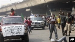 Angry youths protest on the streets following the removal of a fuel subsidy by the government, in Lagos, Nigeria, Thursday, Jan. 12, 2012. A union representing 20,000 oil and gas workers in Nigeria threatened Thursday it would shut down all production st