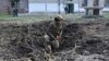 A Ukrainian explosive technician examines the site of an explosion after a Russian missile strike in Kharkiv on April 6, 2024. A Russian microchip company continues to provide chips to Russian arms manufacturers despite its claims it doesn't, VOA has learned.