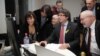 FILE - Axed Catalan president Carles Puigdemont flanked by deposed government's members looks on a computer at the results of the Catalonia's regional elections, at the Square - Brussels Meeting Centre in Brussels on Dec. 21, 2017. 