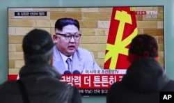 FILE - South Koreans watch a TV news program showing North Korean leader Kim Jong Un's New Year's speech, at the Seoul Railway Station in Seoul, South Korea, Jan. 1, 2018.