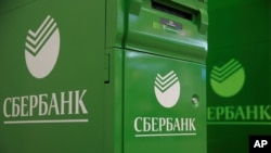 FILE - Logos of Sberbank are seen on automated teller machines (ATM) at its branch in Moscow, Russia, June 10, 2016. 