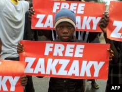 FILE - Protesters from the pro-Iranian Islamic Movement of Nigeria (IMN) carry banners during a march in the streets to press for the release of their leader, Ibrahim Zakzaky, in the northern Nigerian city of Kano, Aug. 11, 2016.