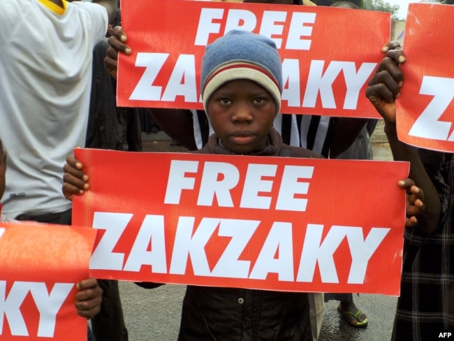 FILE - Protesters from the pro-Iranian Islamic Movement of Nigeria (IMN) carry banners during a march in the streets to press for the release of their leader, Ibrahim Zakzaky, in the northern Nigerian city of Kano, Aug. 11, 2016.