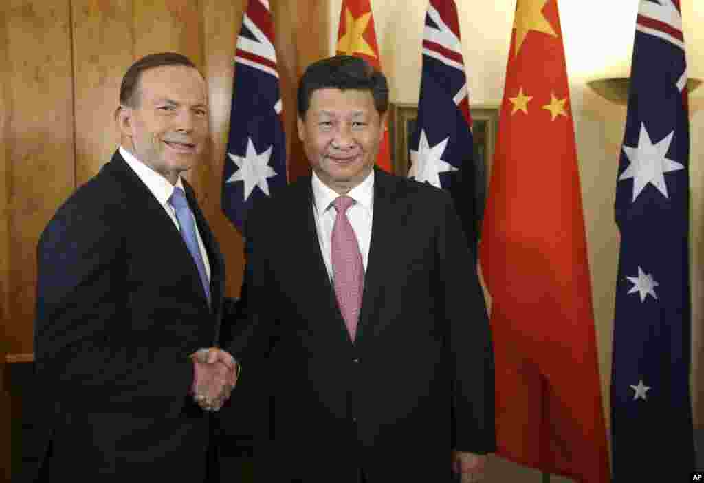 Chinese President Xi Jinping and Australian Prime Minister Tony Abbott shake hands at the start of their bilateral meeting at Parliament House in Canberra, Australia, Nov. 17, 2014.