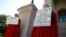 April Houston and Lara Martin hold signs while dressed as Handmaids in protest of Georgia's anti-abortion "heartbeat" bill at the Georgia State Capitol in Atlanta, Georgia, U.S., May 7, 2019. 