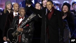 President Barack Obama waves to the crowd with musician B.B. King at the lighting of the National Christmas Tree at the Ellipse across from the White House in Washington, Dec. 9, 2010. 