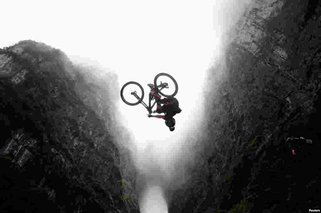 A contestant performs a stunt on a bicycle during a competition in Zhangjiajie, Hunan province, China.