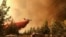 Foto yang dipublikasikan Departemen Kehutanan Oregon menunjukkan sebuah kapal tanker pemadam kebakaran melakukan penurunan di atas Grandview Fire dekat Sisters, Ore., Minggu, 11 Juli 2021.(Foto: AP)