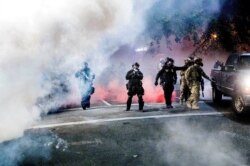 Federal officers use crowd control munitions to disperse Black Lives Matter protesters outside the U.S. Courthouse on July 21, 2020, in Portland, Oregon.