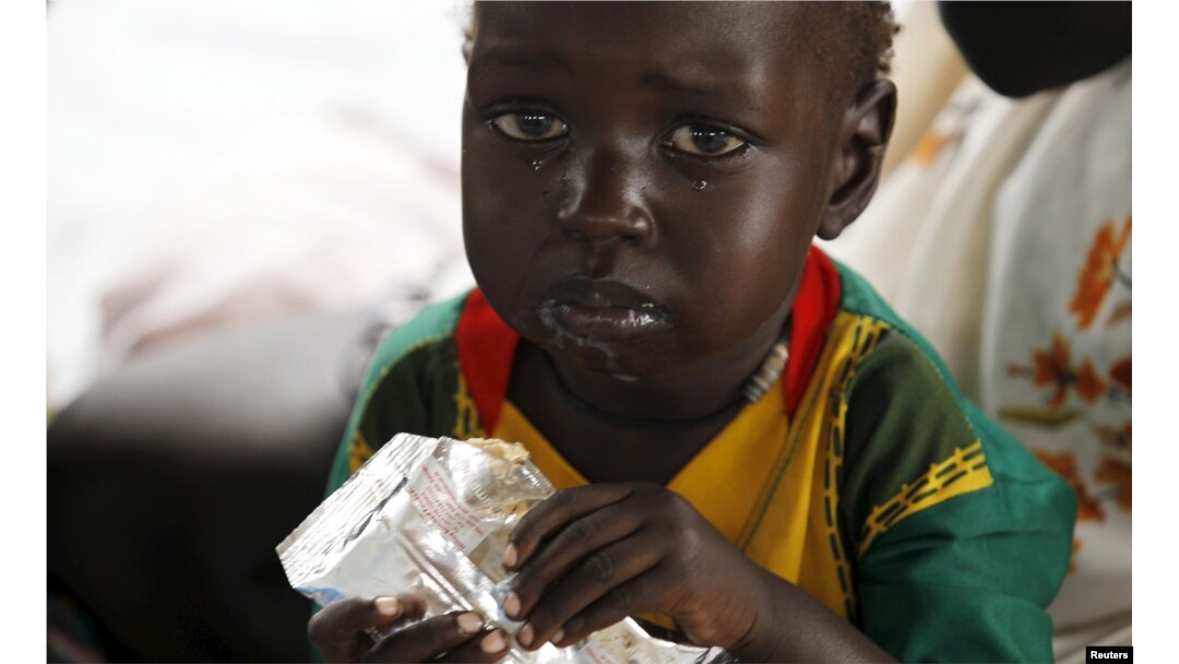 A refugee child from South Sudan feeds on food supplements at a health center at the Kule refugee camp in Ethiopia's Gambella region, April 1, 2015.