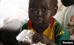 A refugee child from South Sudan feeds on food supplements at a health center at the Kule refugee camp in Ethiopia's Gambella region, April 1, 2015.