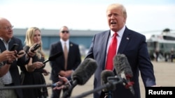 U.S. President Donald Trump speaks to reporters as he boards Air Force One for travel to New Hampshire from Morristown Municipal Airport in Morristown, New Jersey, Aug. 15, 2019. 