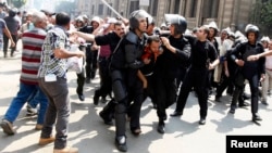 Police detain a supporter of ousted Egyptian President Mohamed Morsi during clashes in central Cairo Aug. 13, 2013. 