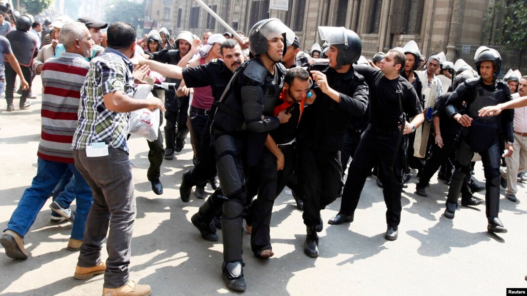 Police detain a supporter of ousted Egyptian President Mohamed Morsi during clashes in central Cairo Aug. 13, 2013. 