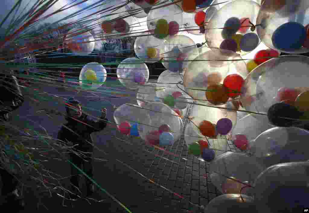 A boy chooses a balloon from a vendor in central Minsk, Belarus.