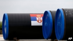 A Serbian flag is seen on a gas pipe on the first section of the Gazprom South Stream natural gas pipeline near the village of Sajkas, 80 kilometers (50 miles) north of Belgrade, Serbia, June 13, 2014.