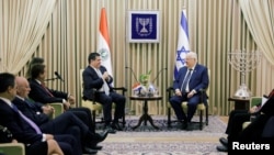 Paraguayan President Horacio Cartes sits next to Israeli President Reuven Rivlin at his residence in Jerusalem, ahead of the dedication ceremony of the embassy of Paraguay in Jerusalem, May 21, 2018.