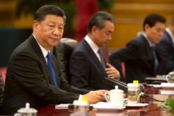 FILE - In this July 2, 2019, file photo, Chinese President Xi Jinping sits during a meeting at the Great Hall of the People in Beijing.