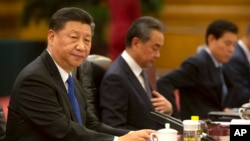 FILE - In this July 2, 2019, file photo, Chinese President Xi Jinping sits during a meeting at the Great Hall of the People in Beijing. Chinese authorities have declined to renew the press credentials of a Beijing-based Wall Street Journal reporter…