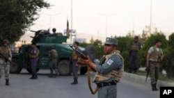 Afghan security personnel secure the site of an attack in Kabul, Afghanistan, July 28, 2019. 