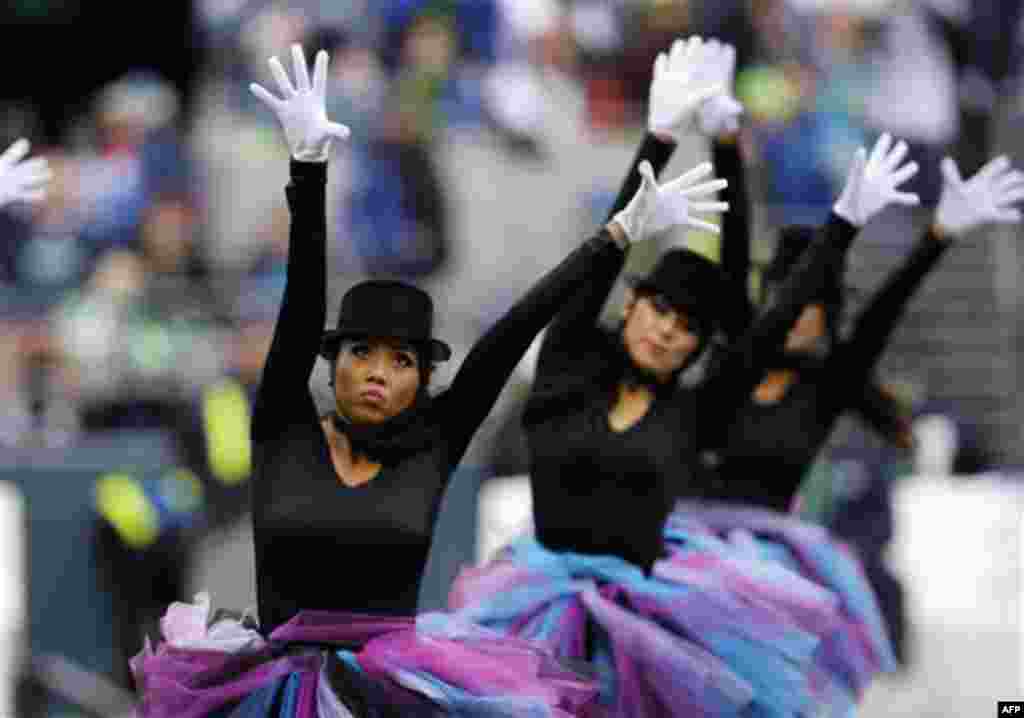 CORRECTS PERFORMERS TO FORMER SEA GALS AND ADDS LOCAL DANCERS - Former Seattle Seahawks Sea Gals and local dancers perform a Halloween production at halftime as the Seahawks plays against the Cincinnati Bengals in an NFL football game, Sunday, Oct. 30, 20