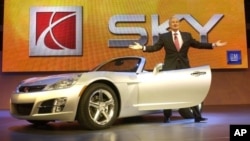 Gary Cowger, President, General Motors North America, steps out of new 2007 Saturn Sky Roadster during rehearsal for its formal unveiling, North American International Auto Show, Detroit, Jan. 9, 2005.