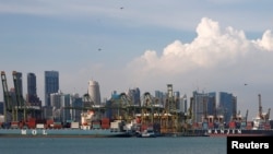 FILE - Container ships docked at PSA's Tanjong Pagar container terminal in Singapore, Sept. 28, 2016. 