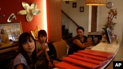 Receptionists at the empty Indara massage shop in Bangkok