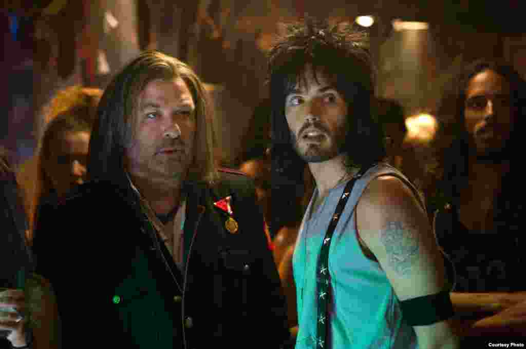 (L-r) ALEC BALDWIN as Dennis Dupree and RUSSELL BRAND as Lonny in New Line Cinema’s rock musical “ROCK OF AGES,” a Warner Bros. Pictures release. (Photo: Warner Bros. / David James)