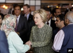 Democratic presidential hopeful Hillary Clinton greets people at the Jackson Diner in the Queens borough of New York, April 11, 2016.