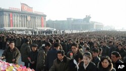 North Koreans offer flowers to mark the birth anniversary of the North's late leader Kim Jong-Il at Kim Il-sung square in Pyongyang, in this photo taken by Kyodo, February 16, 2012.