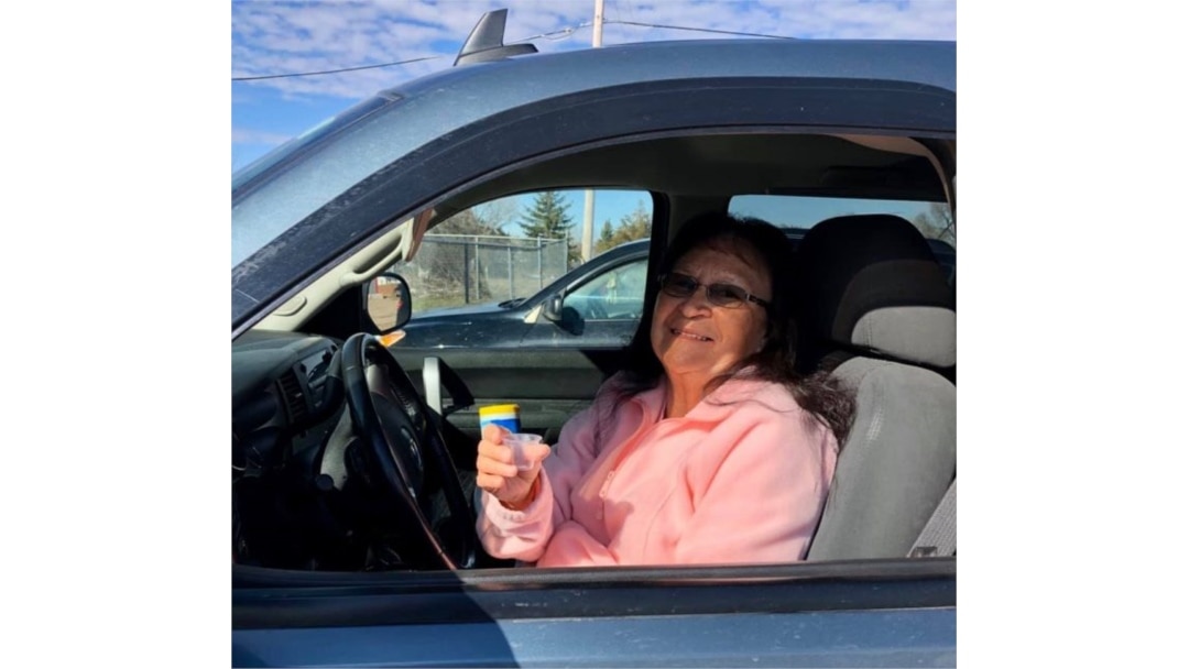 Rosebud Episcopal Mission worshipper Sandra Wilcox receiving communal wine "on the go" before wine was removed from sacrament due to COVID. (Courtesy: Rev. Lauren Stanley)