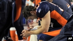 Denver Broncos quarterback Tim Tebow (15) prays while sitting on the bench late in the fourth quarter of an NFL football game against the Kansas City Chiefs, January 1, 2012, in Denver.