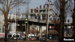 Workers fix a wire at the site of a blast outside a chemical plant in Zhangjiakou, Hebei province, China, Nov. 28, 2018. 