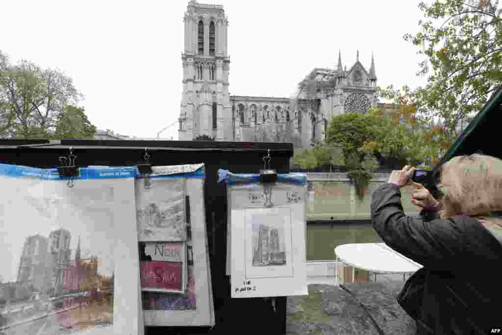 A vintage picture of Notre-Dame-de-Paris cathedral is displayed outside the Cathedral a day after a fire devastated the 12th-century landmark in central Paris, France.