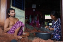 Puth Thavy, 38, takes a break at a typical Sunday lunch time after he comes back from fishing, in Battambang province, on September 26, 2021. (Khan Sokummono/VOA Khmer)