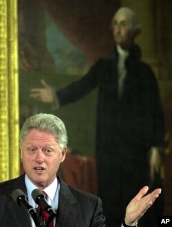 President Bill Clinton (42nd president) delivers remarks in the East Room of the White House with a portrait of George Washington (first president) behind him, Feb. 14, 2000.