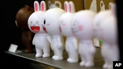 FILE - Figures of Cony the bunny, one of Line's characters, are displayed at the Line Friends flagship shop in Seoul, South Korea.