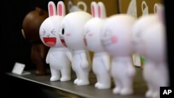 FILE - Figures of Cony the bunny, one of Line's characters, are displayed at the Line Friends flagship shop in Seoul, South Korea.
