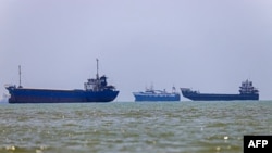 (FILES) In this picture obtained from Iran's ISNA news agency on June 18, 2026, vessels are seen anchored in Bandar Abbas along the Strait of Hormuz.